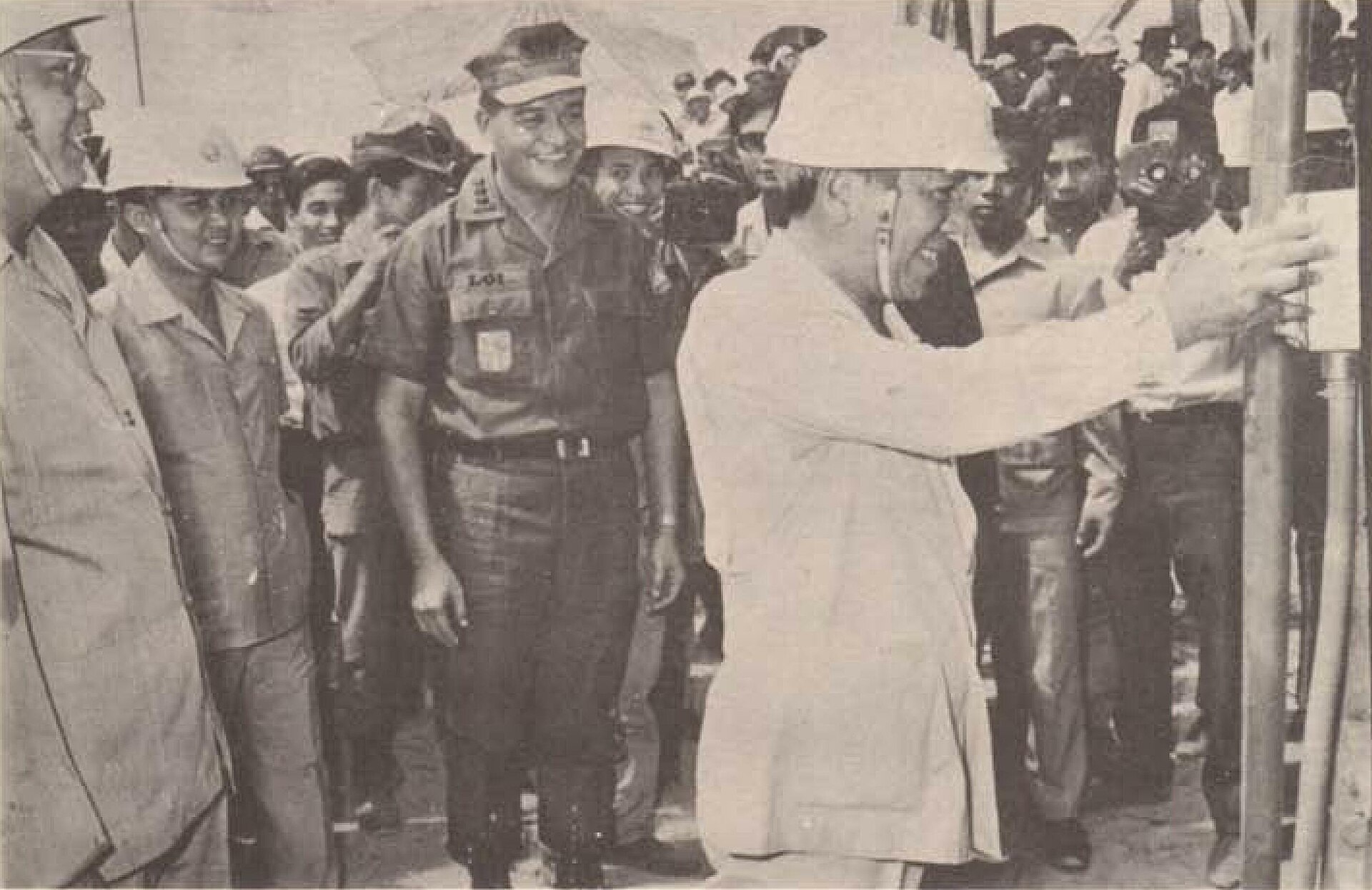 Photograph of President Nguyễn Văn Thiệu wearing a safety helmet. Caption: I am determined to Lead the Country in a Profound Economic and Social Revolution.