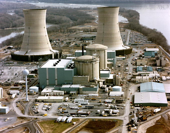 Color photograph of the Three Mile Island nuclear generating station, which suffered a partial meltdown in 1979. The reactors are in the smaller domes with rounded tops (the large smokestacks are just