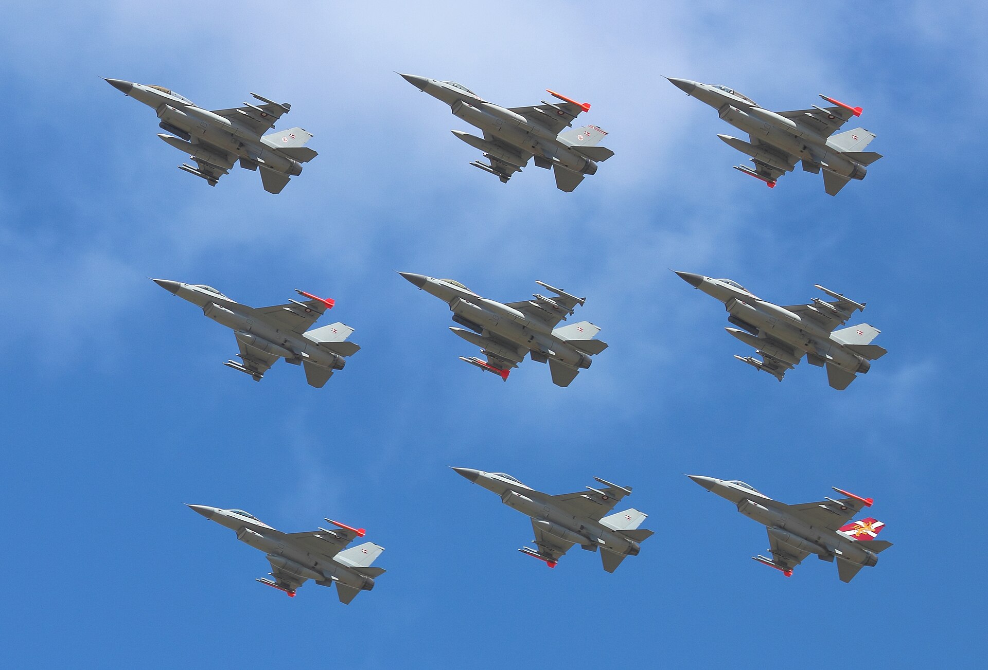 A diamond formation of nine General Dynamics F-16 Fighting Falcon aircraft from Squadrons 727 and 730, Fighter Wing Skrydstrup, Royal Danish Air Force on a display flight at Danish Air Show 2014. At t